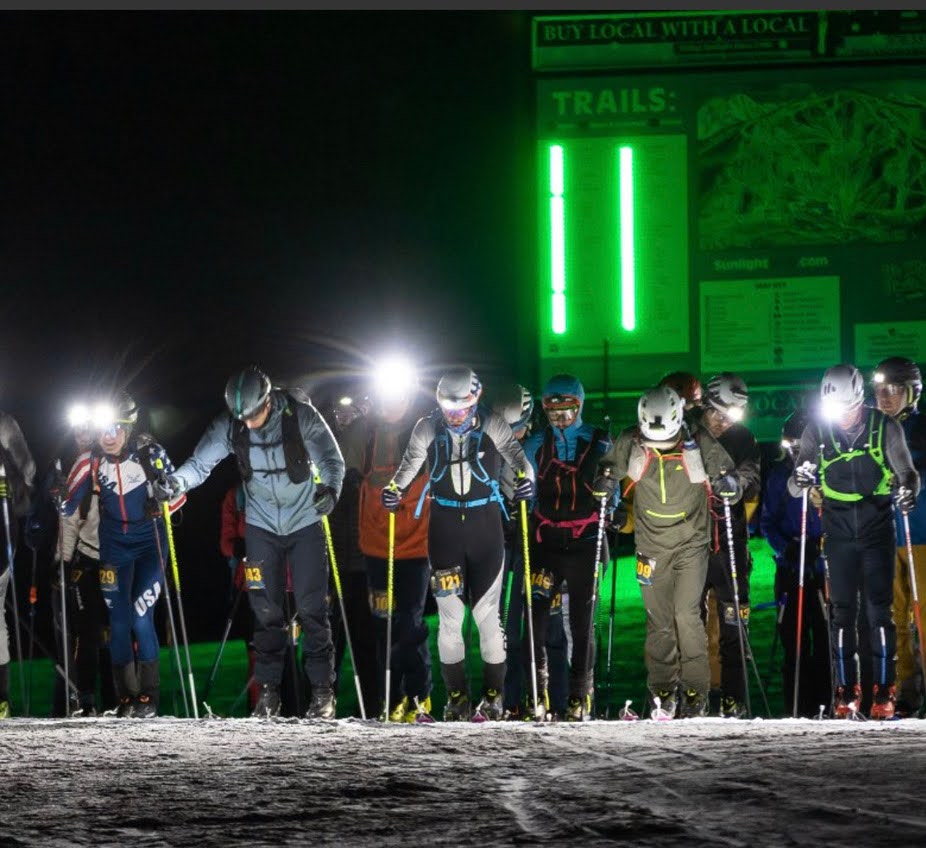 SkiMo racers at night start line with headlamps